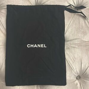 Black Chanel, soft, leathery, cotton silk feel with ribbon ties. 
Made in Italy